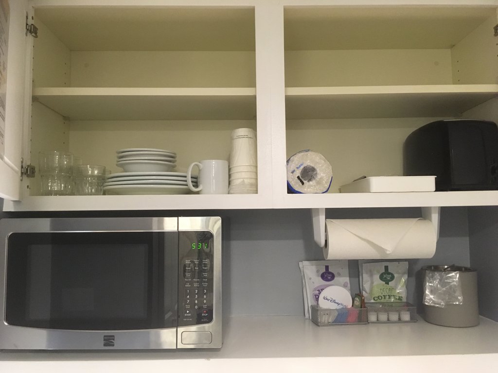 Kitchen Are | Toaster, Glasses, Paper Cups, Bowls, Plates, Plastic Utensils, and Mug at Cabinet