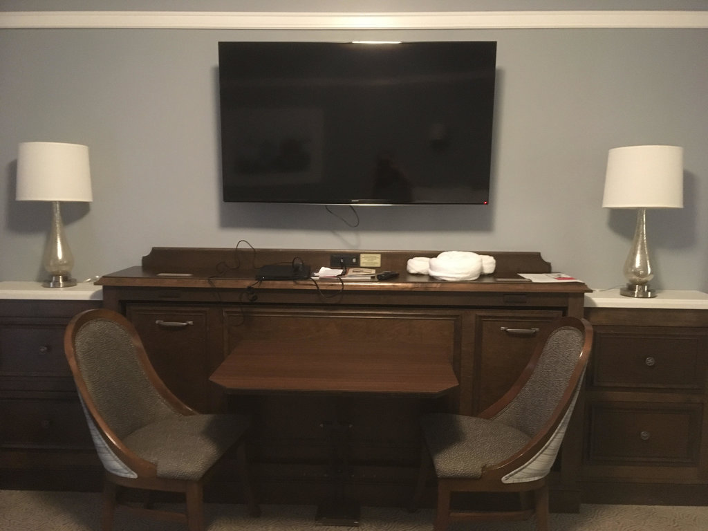 Beach Villas | Table With TV Attached On The Wall Above It