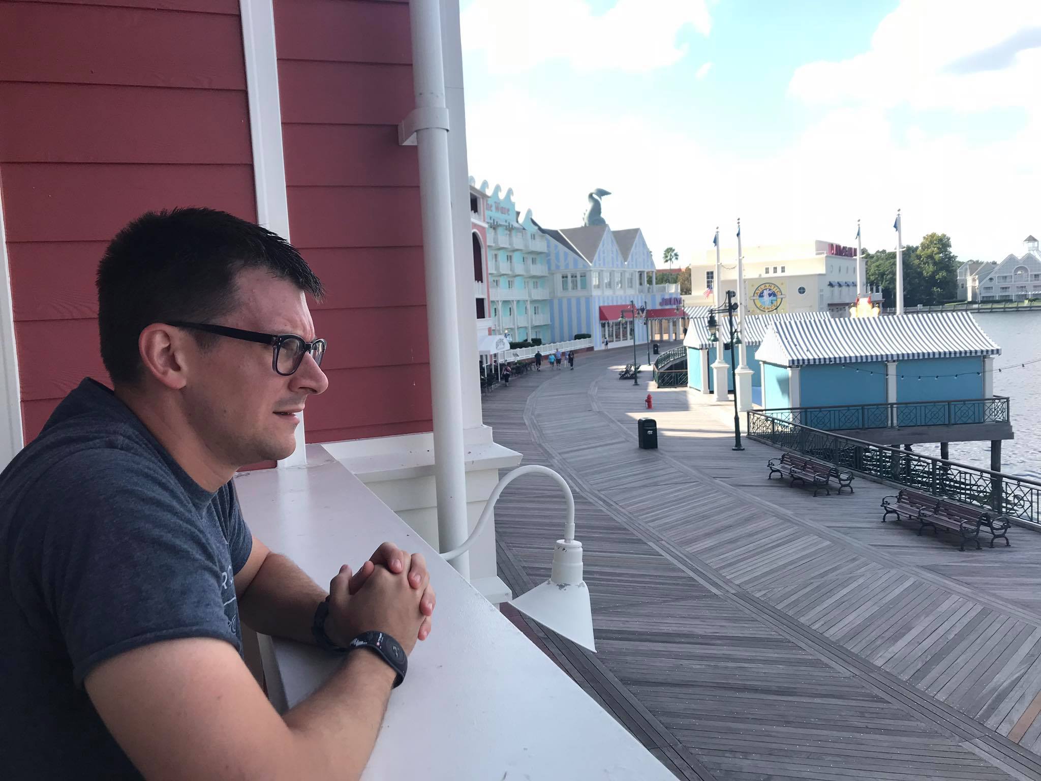 Boardwalk Villas Deluxe Studio | A Man Looking Outside The Balcony