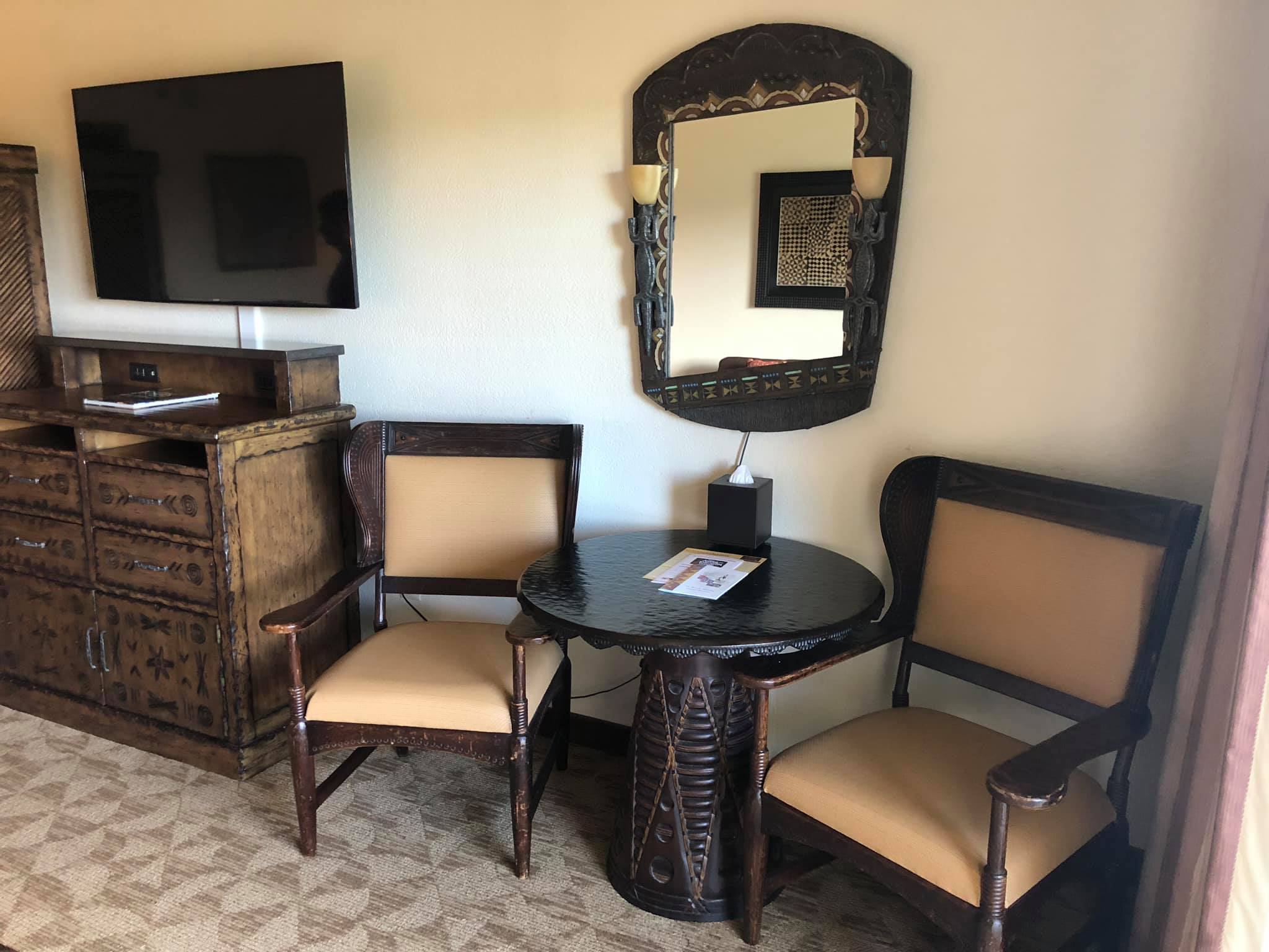 Animal Kingdom Villas | A Table With 2 Chairs and A Mirror Attached on the Wall