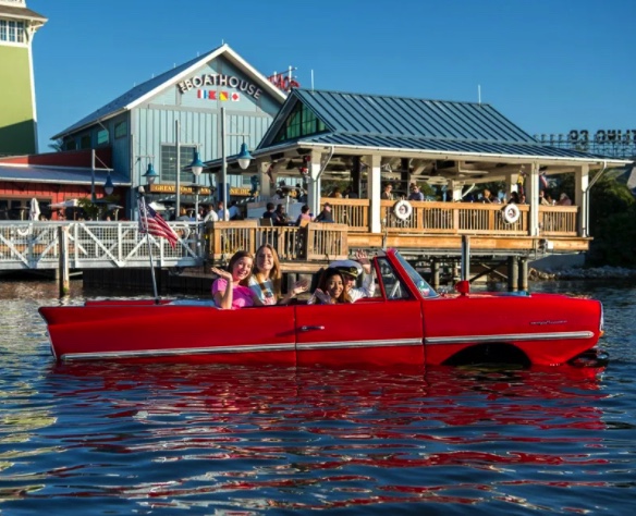 Saratoga Spring Resort | People riding an Amphicar At the Lake