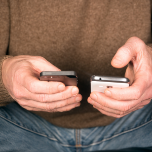 Disney Genie Drawbacks | Man Holding Two Smartphones