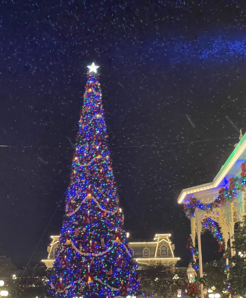 Giant Christmas tree on Main Street, U.S.A. with (Florida) Snow falling during Mickey’s Very Merry Christmas Party at Magic Kingdom